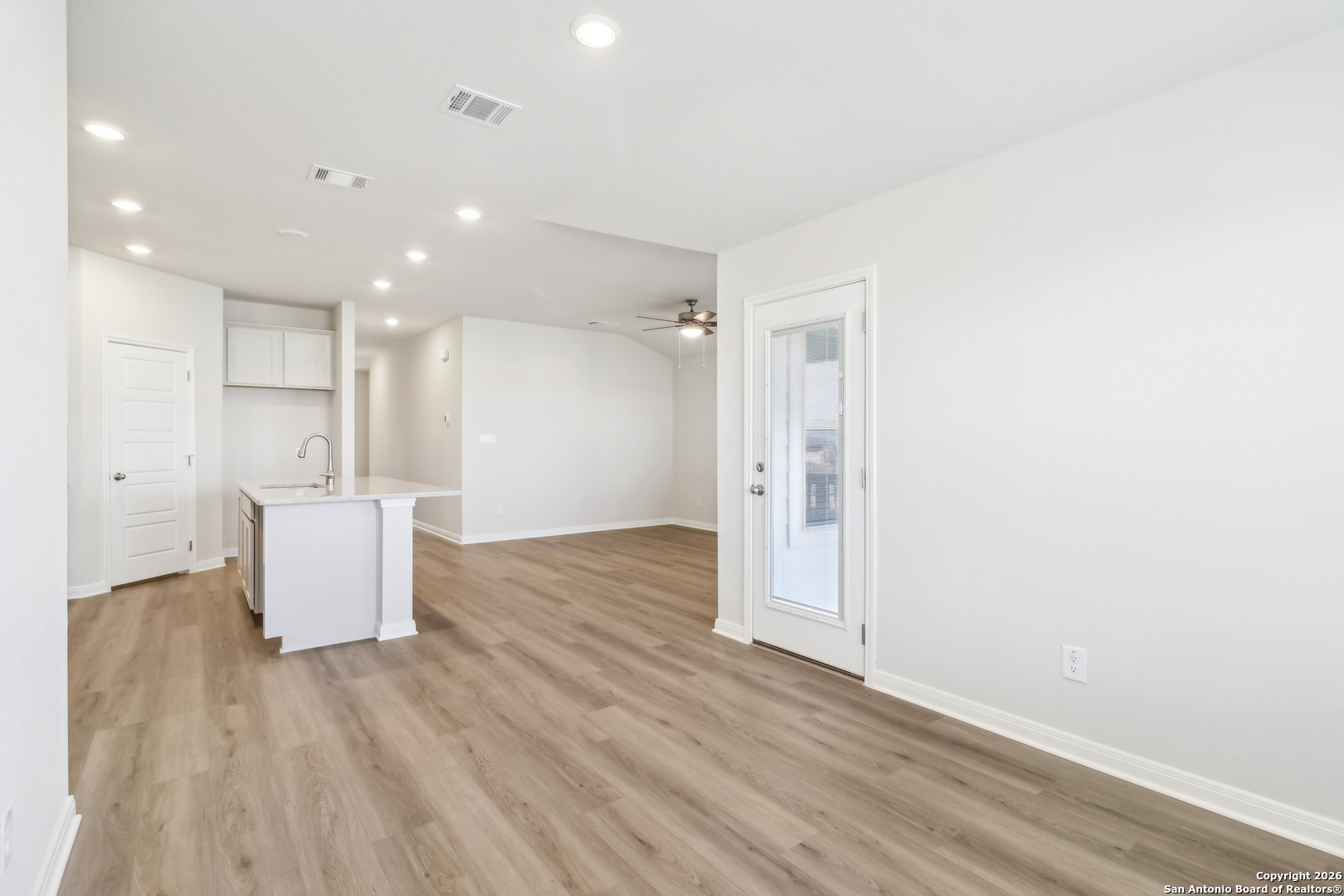 2907 Junction Bay Converse, TX 78109 - Photo 10 of 21 an empty room with wooden floor and windows