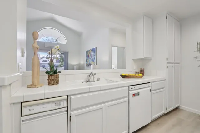 a kitchen with white cabinets and a sink
