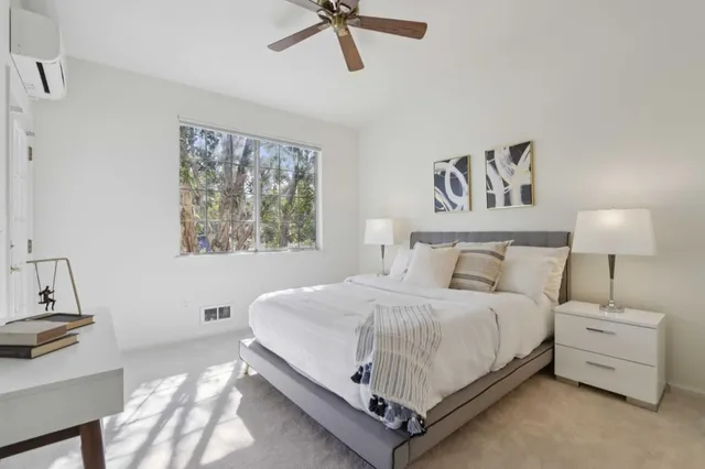 a bedroom with a bed and a table