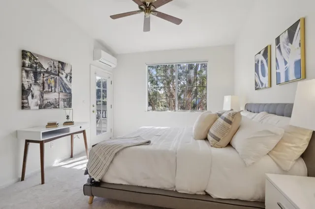 a bedroom with a bed and a desk