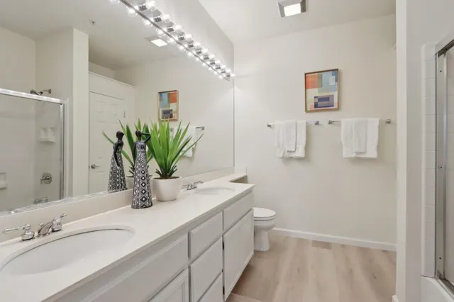 a bathroom with a double vanity sink and a mirror
