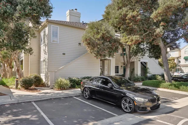 a car parked in front of a white house