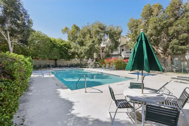 a view of a house with backyard and a tree
