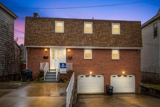 259 Republic Street Pittsburgh, PA 15211 - Photo 1 of 25 a front view of a house with garage