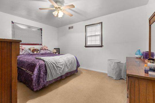 259 Republic Street Pittsburgh, PA 15211 - Photo 11 of 25 a bedroom with a bed and a chandelier