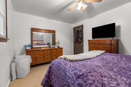 259 Republic Street Pittsburgh, PA 15211 - Photo 12 of 25 a bedroom with a bed and a flat screen tv