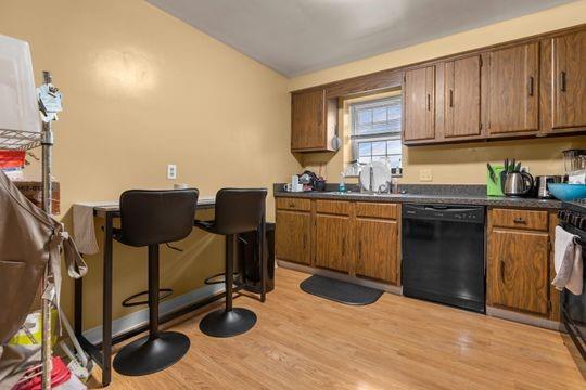 259 Republic Street Pittsburgh, PA 15211 - Photo 19 of 25 a kitchen with stainless steel appliances granite countertop a sink wooden cabinets and a granite counter top