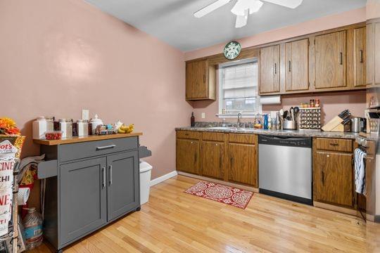 259 Republic Street Pittsburgh, PA 15211 - Photo 9 of 25 a kitchen with stainless steel appliances a sink cabinets and wooden floor
