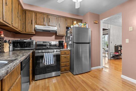 259 Republic Street Pittsburgh, PA 15211 - Photo 10 of 25 a kitchen with granite countertop a refrigerator stove and wooden cabinets
