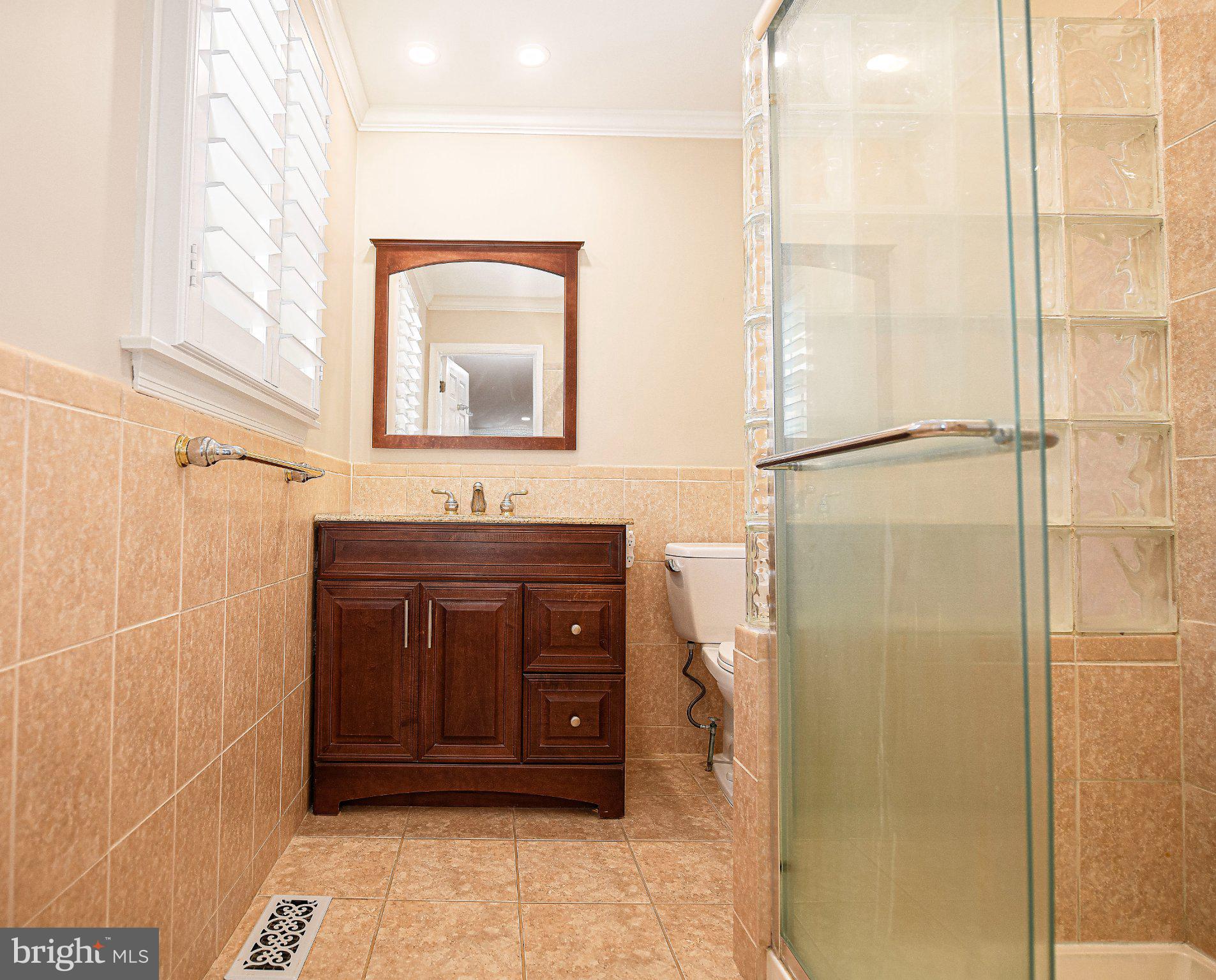 14300 Carroll Ridge Court Baldwin, MD 21013 - Photo 31 of 73 a bathroom with a granite countertop shower mirror and a sink