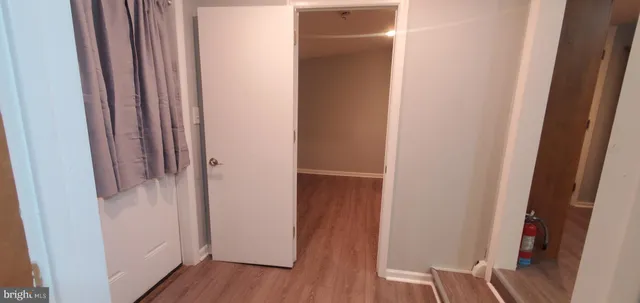 a view of a room with wooden floor