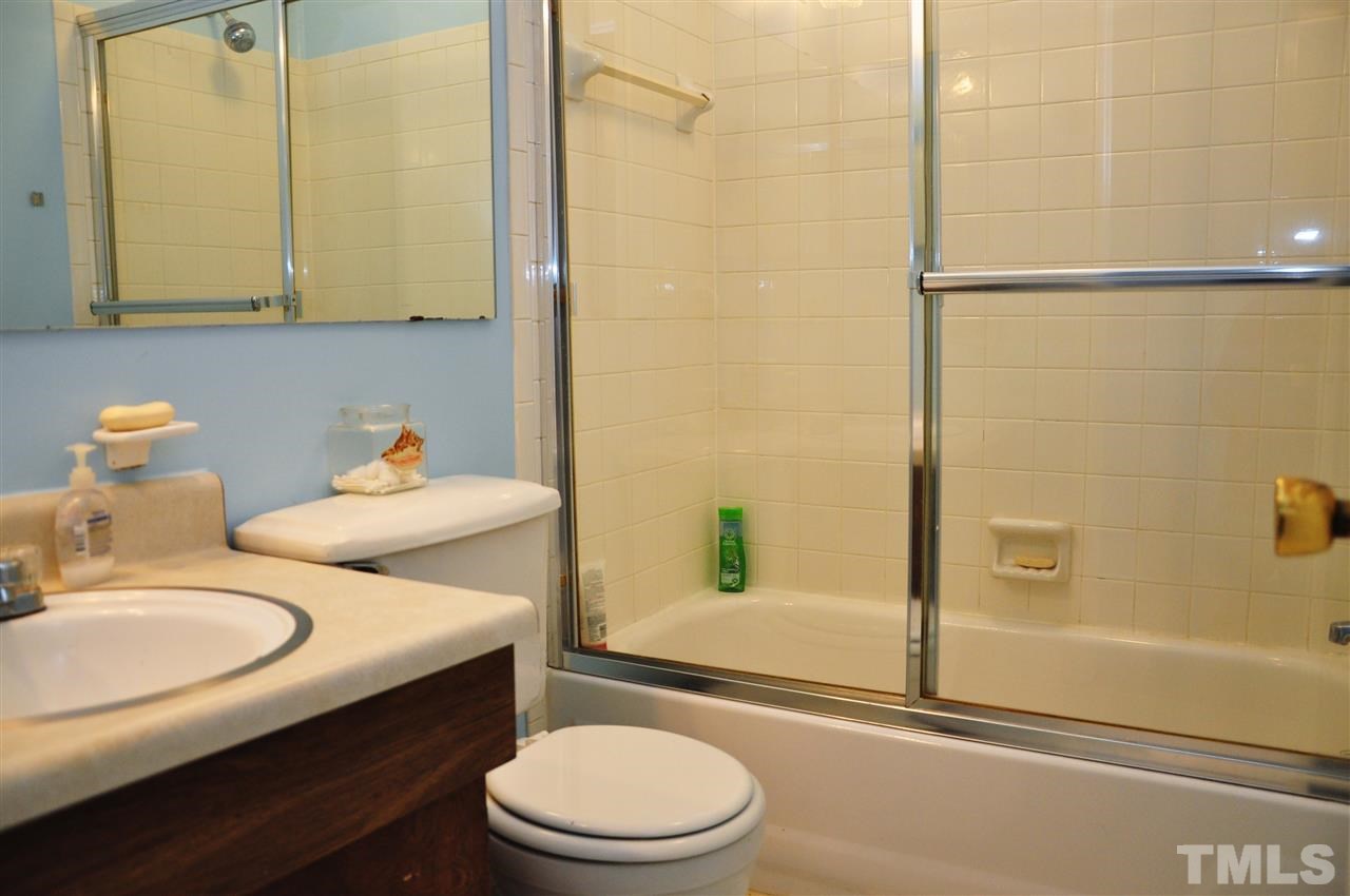 1774 Quail Ridge Road Raleigh, NC 27609 - Photo 14 of 25 a bathroom with a sink toilet and shower