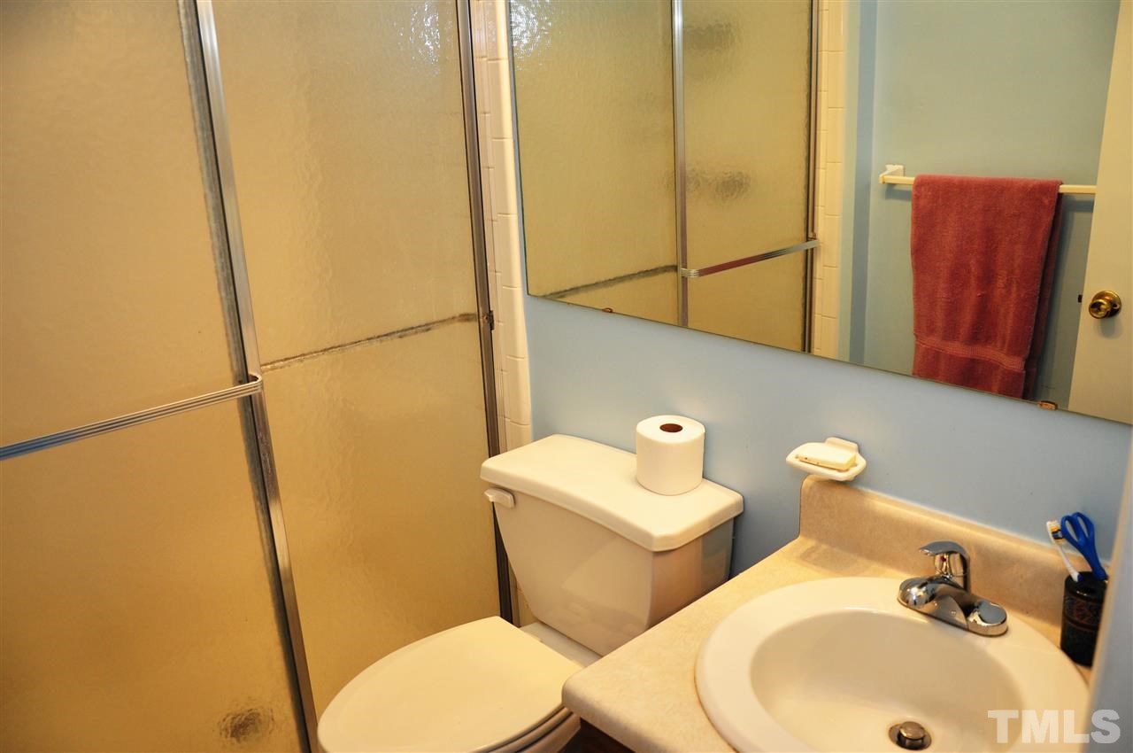 1774 Quail Ridge Road Raleigh, NC 27609 - Photo 15 of 25 a bathroom with a sink and mirror with toilet