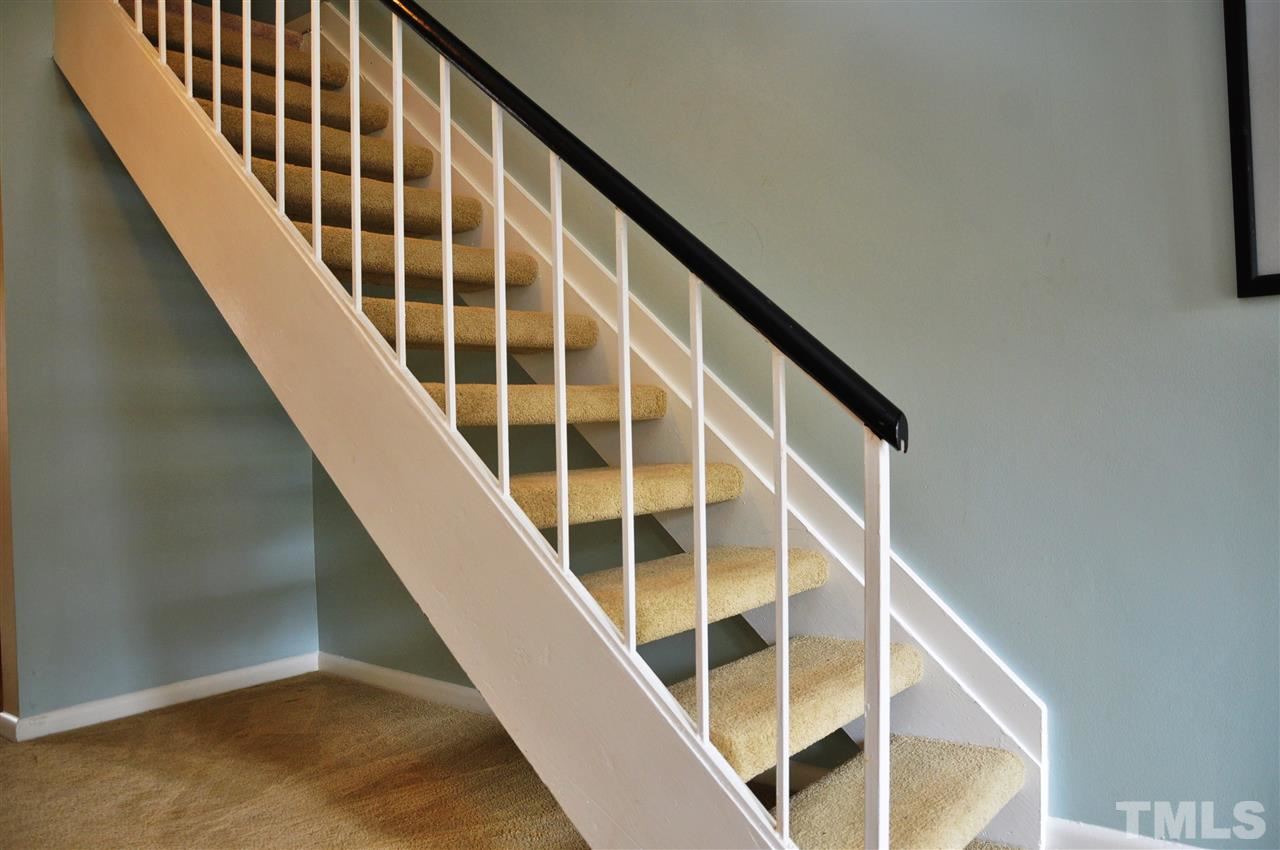 1774 Quail Ridge Road Raleigh, NC 27609 - Photo 4 of 25 a view of staircase with wooden floor and stairs