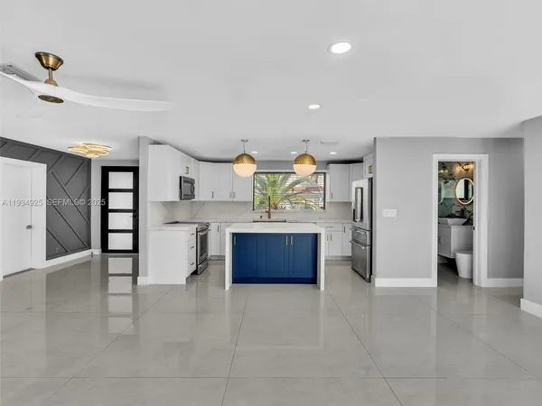 a kitchen with stainless steel appliances a refrigerator and a stove