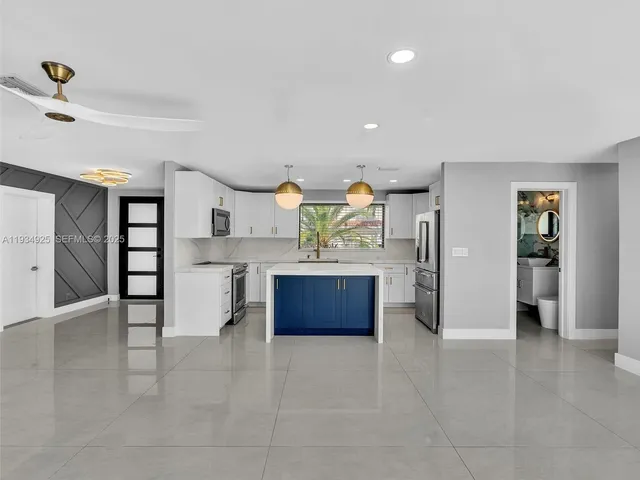 a kitchen with stainless steel appliances a refrigerator and a stove