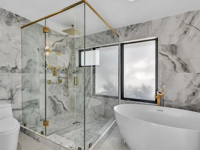 a bathroom with a bathtub and a shower