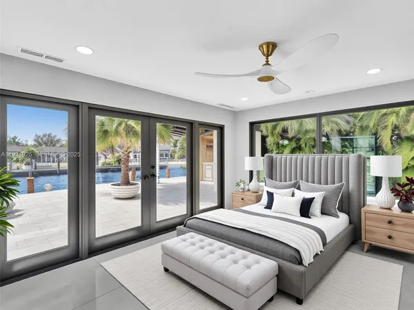 a bedroom with a bed and large window