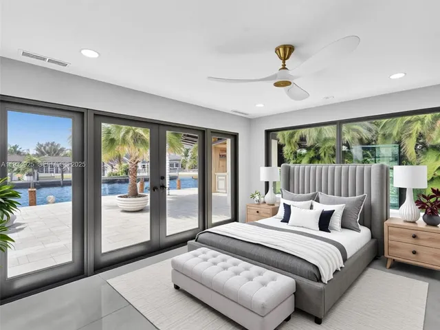 a bedroom with a bed and large window