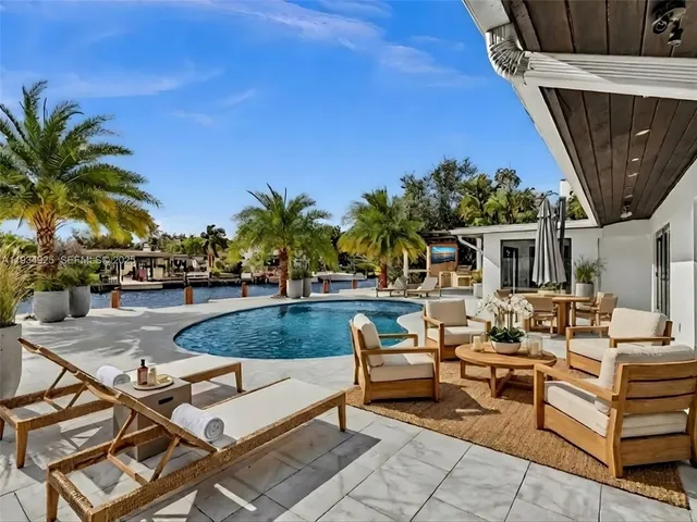 a view of a patio with swimming pool table and chairs