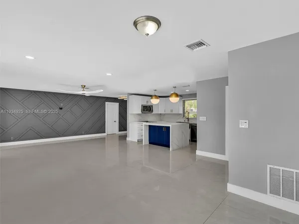 a view of a kitchen with a sink and cabinets