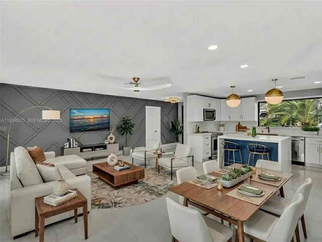 a living room with furniture kitchen view and a fireplace