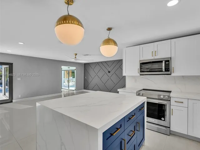a kitchen with a stove cabinets and microwave