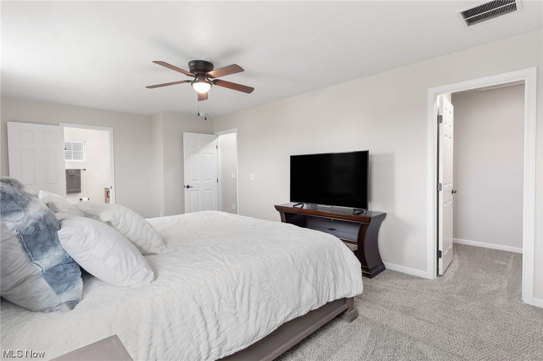 2113 Fowl Road Elyria, OH 44035 - Photo 25 of 39 Bedroom with ensuite bathroom, ceiling fan, and light carpet