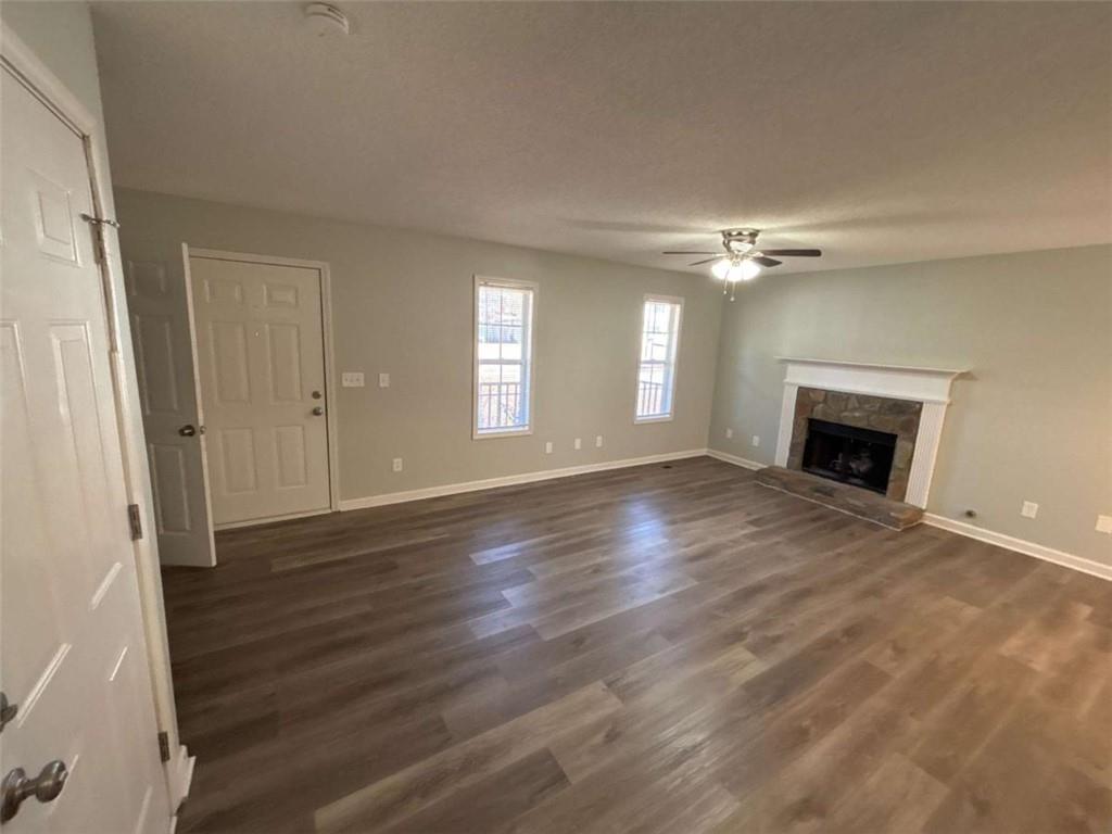 732 Newport Drive Villa Rica, GA 30180 - Photo 11 of 44 an empty room with wooden floor and fireplace