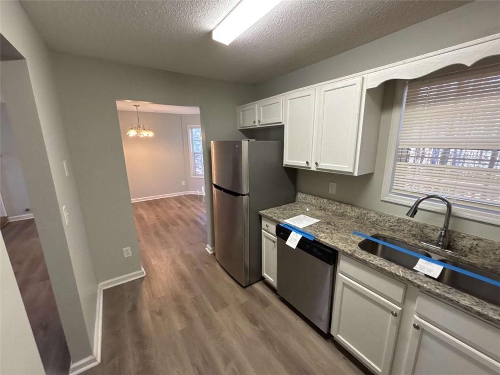 732 Newport Drive Villa Rica, GA 30180 - Photo 13 of 44 a kitchen with granite countertop a refrigerator and a sink
