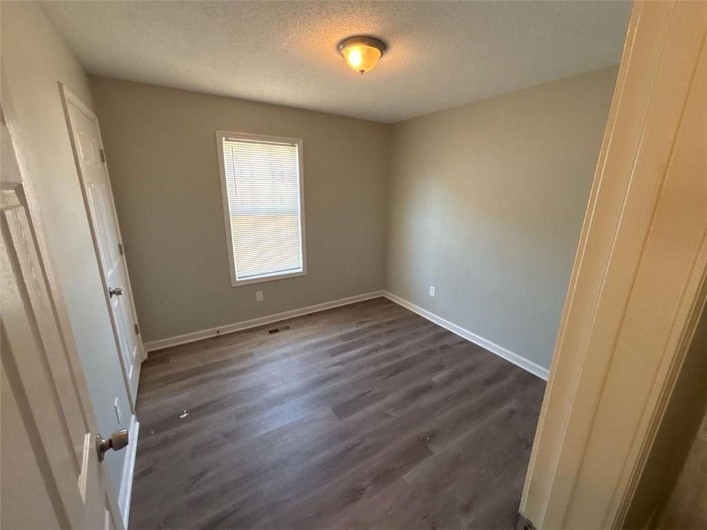732 Newport Drive Villa Rica, GA 30180 - Photo 27 of 44 an empty room with wooden floor and window