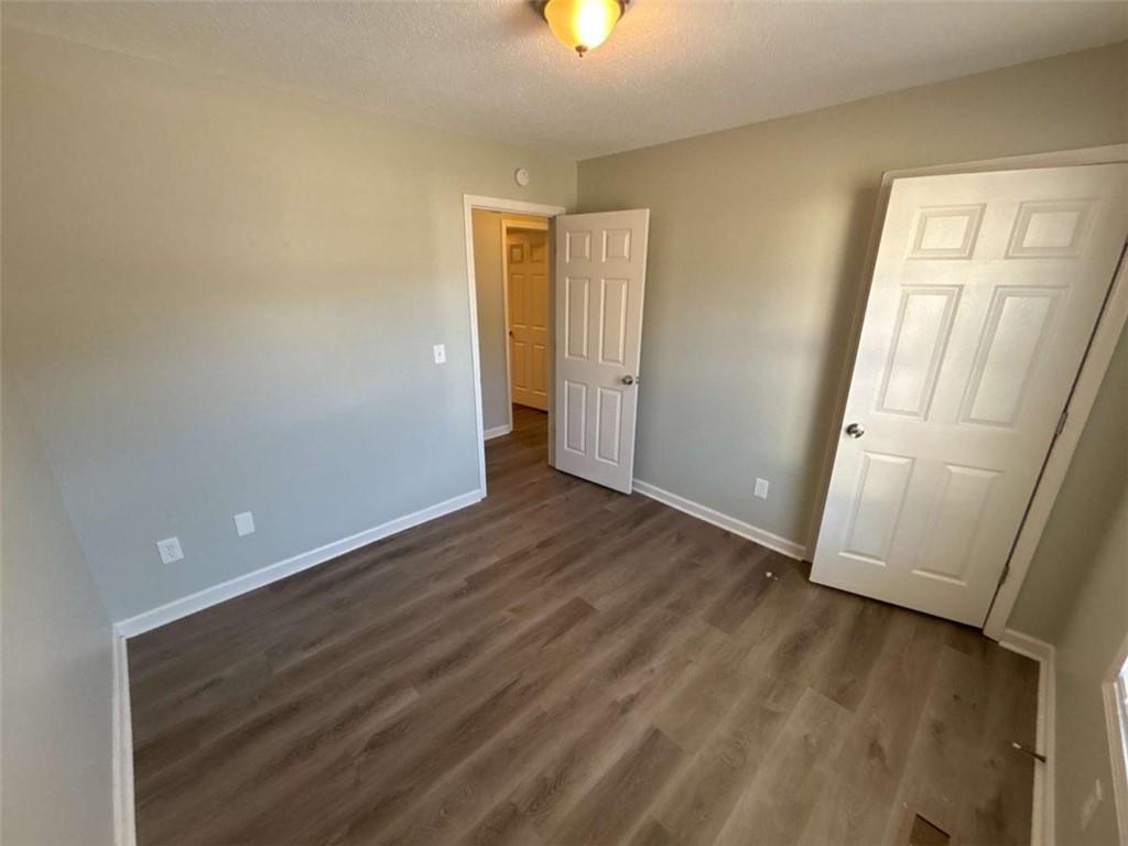 732 Newport Drive Villa Rica, GA 30180 - Photo 29 of 44 wooden floor in an empty room with a window