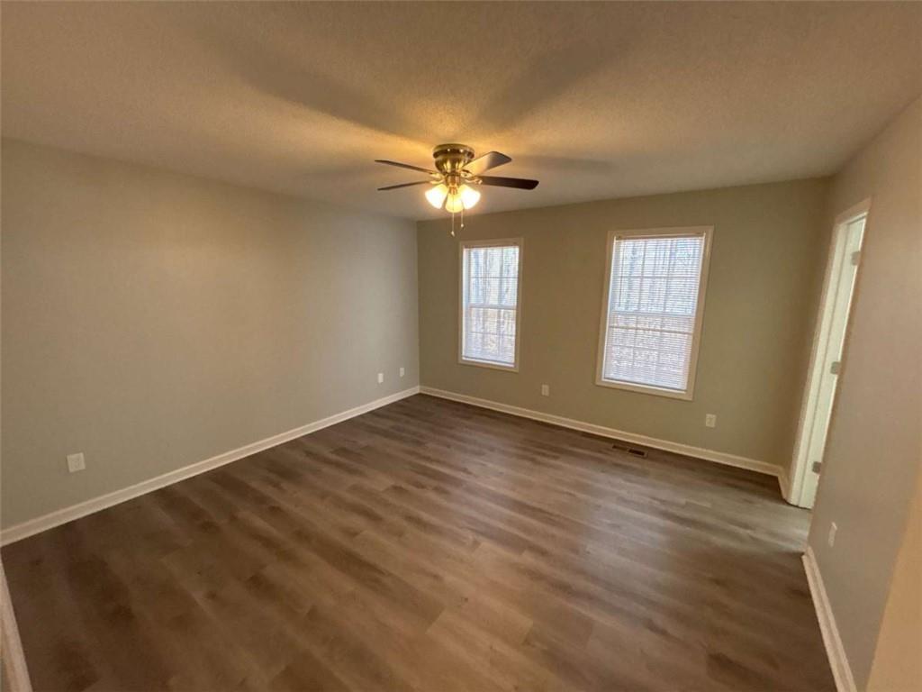 732 Newport Drive Villa Rica, GA 30180 - Photo 30 of 44 an empty room with windows and fan