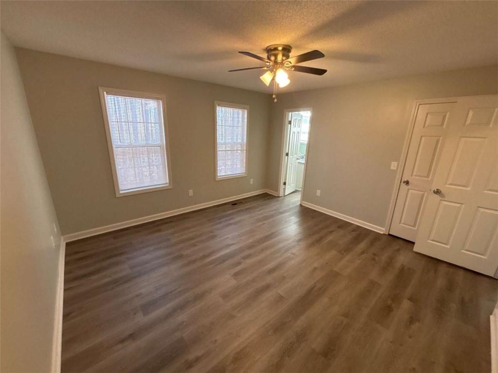 732 Newport Drive Villa Rica, GA 30180 - Photo 32 of 44 a view of an empty room with wooden floor and window