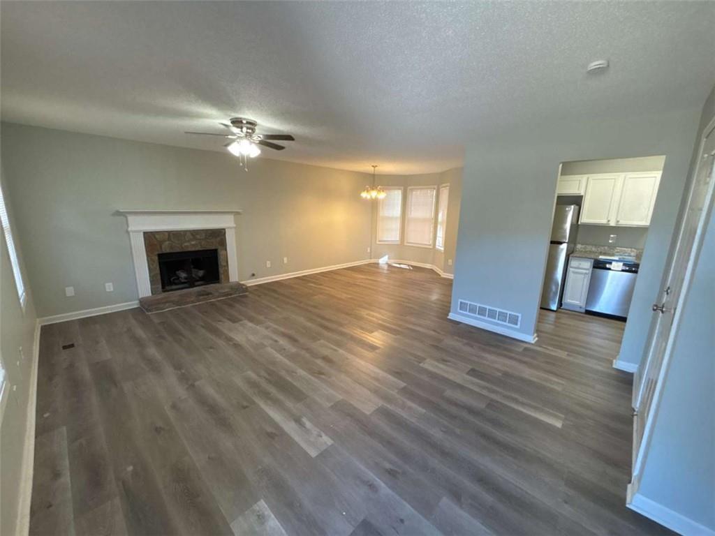 732 Newport Drive Villa Rica, GA 30180 - Photo 7 of 44 wooden floor fireplace and windows in an empty room