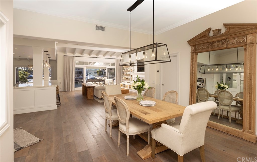 56 Balboa Newport Beach, CA 92663 - Photo 14 of 37 a view of a dining room and livingroom with furniture wooden floor a chandelier