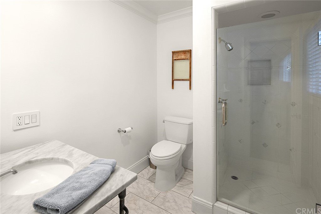 56 Balboa Newport Beach, CA 92663 - Photo 23 of 37 a bathroom with a toilet sink and shower