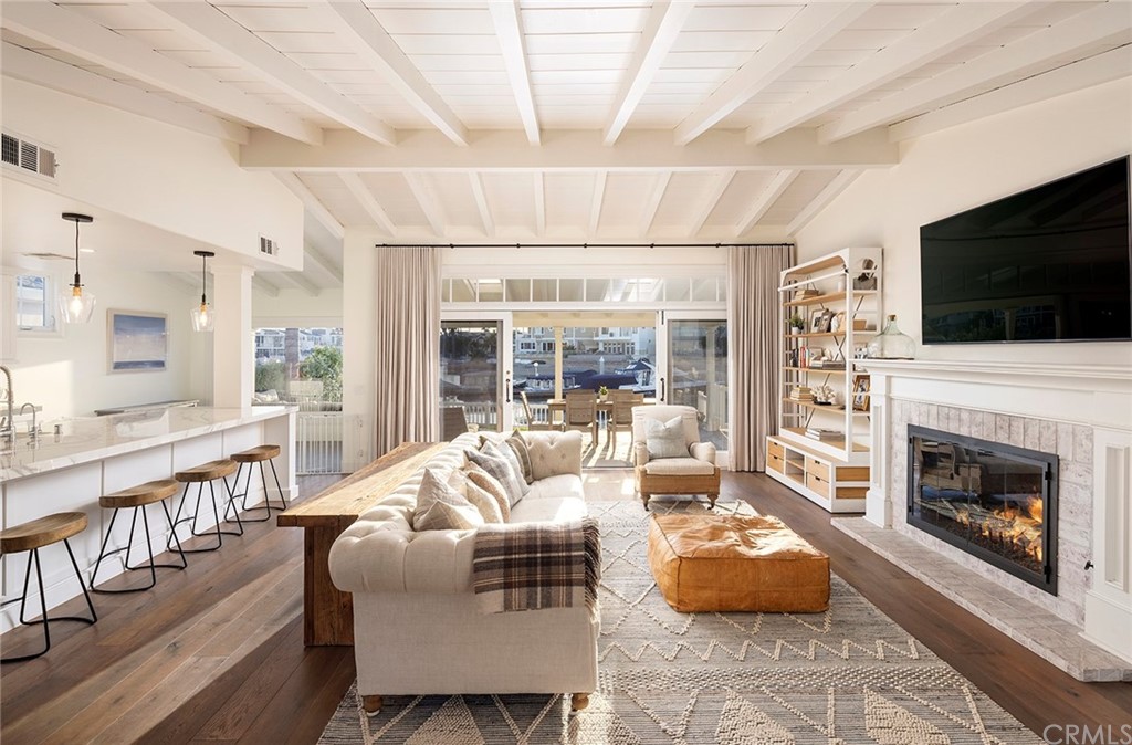 56 Balboa Newport Beach, CA 92663 - Photo 5 of 37 a living room with furniture a flat screen tv and a fireplace