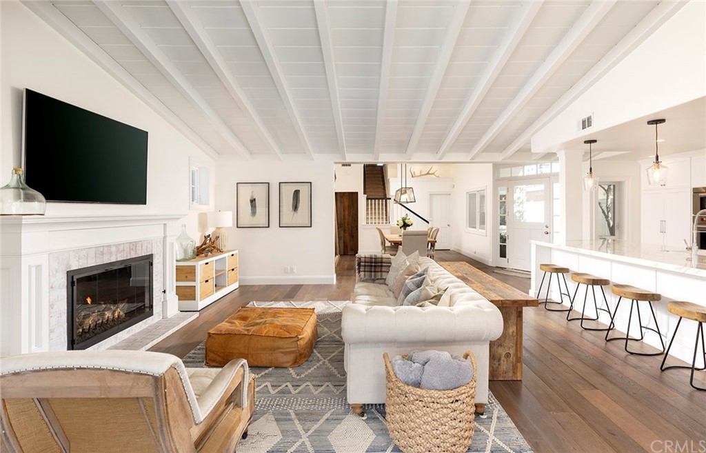 56 Balboa Newport Beach, CA 92663 - Photo 7 of 37 a living room with furniture a flat screen tv and a fireplace