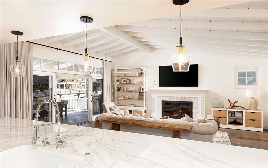 56 Balboa Newport Beach, CA 92663 - Photo 9 of 37 a living room with furniture a flat screen tv and a fireplace