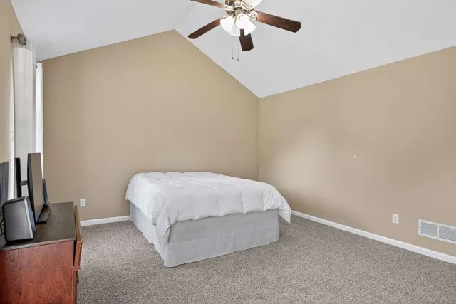 a room with a bed and a flat screen tv