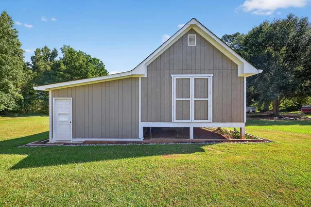 a front view of house with yard and garage