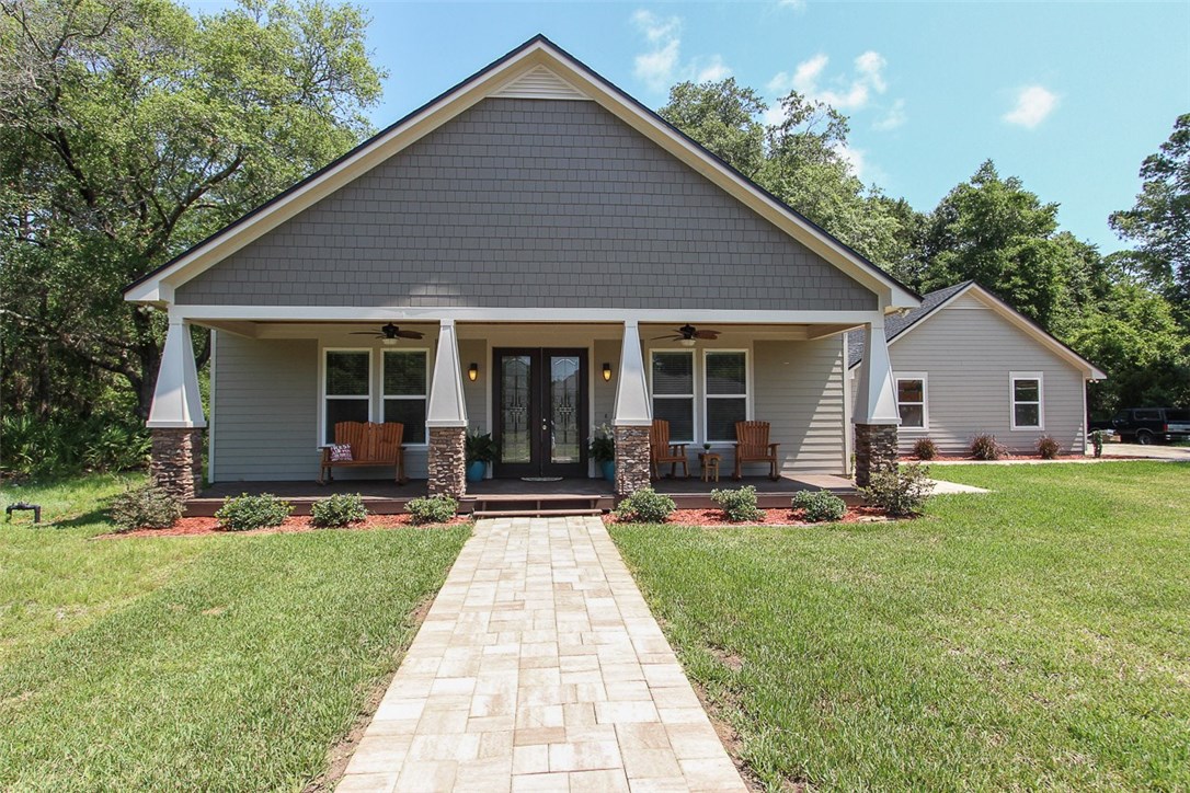 96155 Captains Pointe Road Yulee, FL 32097 - Photo 1 of 30 a front view of house with a garden and patio