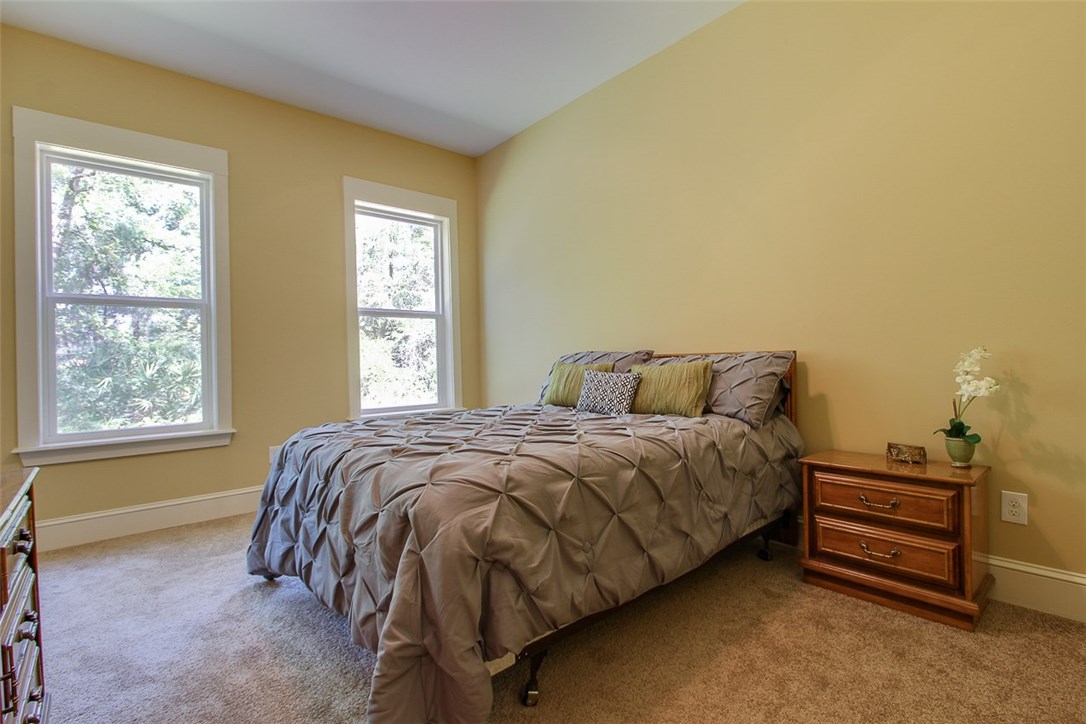 96155 Captains Pointe Road Yulee, FL 32097 - Photo 18 of 30 a bed sitting in a bedroom next to a window
