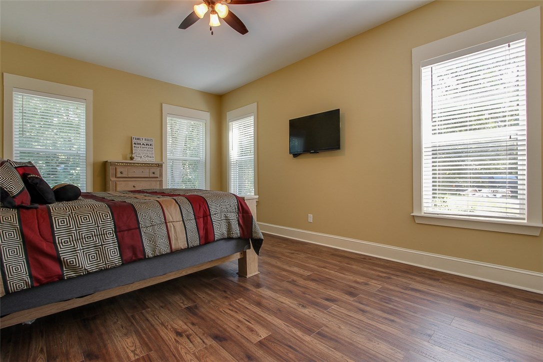 96155 Captains Pointe Road Yulee, FL 32097 - Photo 19 of 30 a spacious bedroom with a bed and a chandelier