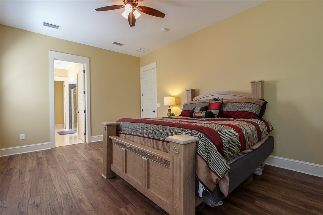 96155 Captains Pointe Road Yulee, FL 32097 - Photo 20 of 30 a bedroom with a bed and a chandelier