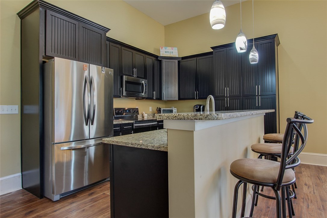 96155 Captains Pointe Road Yulee, FL 32097 - Photo 2 of 30 a kitchen with kitchen island a counter top space cabinets and stainless steel appliances