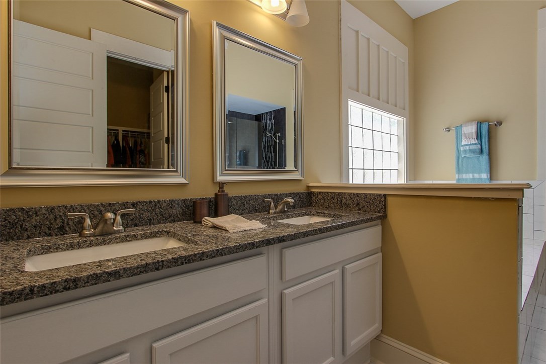 96155 Captains Pointe Road Yulee, FL 32097 - Photo 21 of 30 a bathroom with a granite countertop sink and a mirror