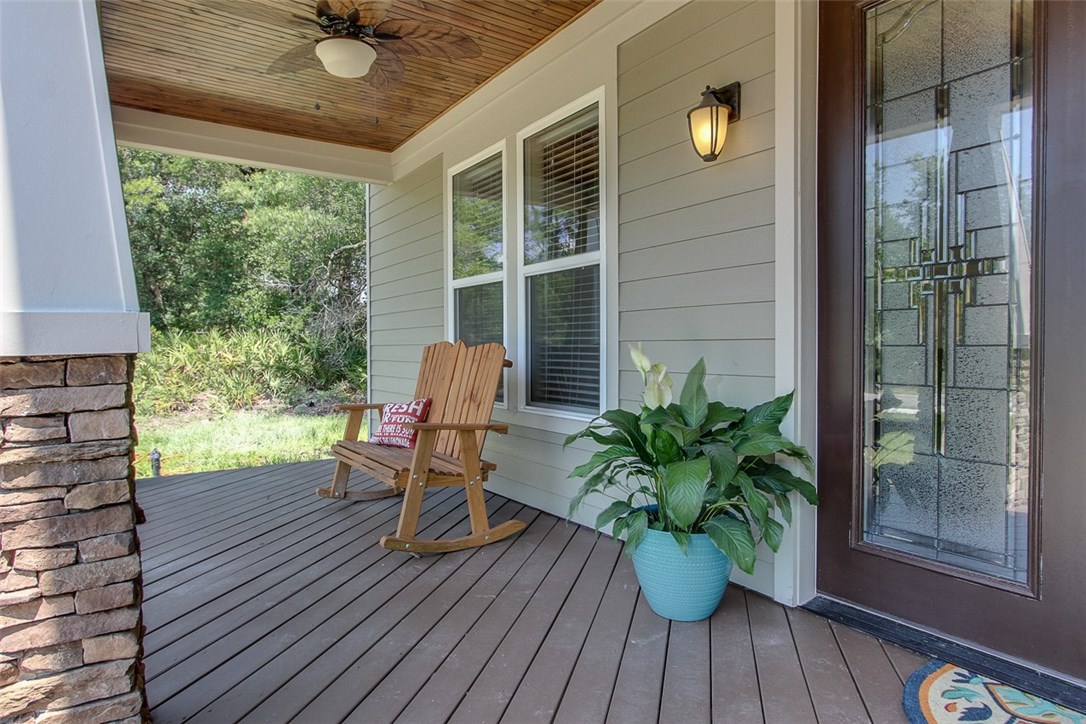 96155 Captains Pointe Road Yulee, FL 32097 - Photo 29 of 30 a view of a deck with table and chairs potted plants with wooden floor