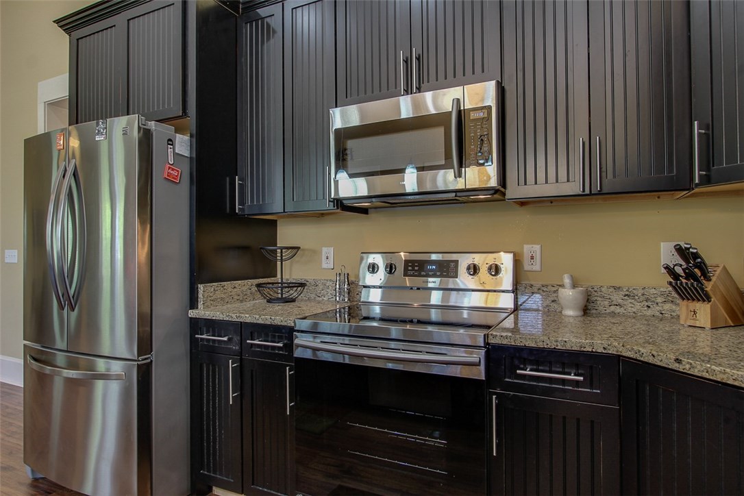 96155 Captains Pointe Road Yulee, FL 32097 - Photo 9 of 30 a kitchen with granite countertop stainless steel appliances and wooden cabinets